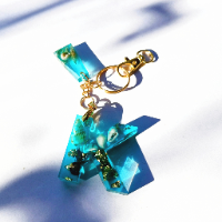 Handcrafted English letter keychain from A to Z, featuring a glossy finish with colorful glitter and unique patterns.