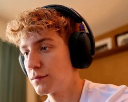 אוזניות אלחוטיות צבע שחור Logitech G325 – צעיר עם שיער ג ינג י חובש אוזניות שחורות אלחוטיות על ראשו פריט בודד