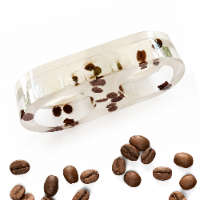 Handcrafted double oval clear resin candlestick filled with real coffee beans, on a white background.
