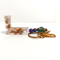 Handcrafted personalized letter keychain with a vibrant colorful design and a sturdy metal ring.