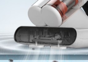 שואב אבק לספות ומזרנים Deerma CM980 – ראש השואב הלבן עם חלק שקוף מונח על משטח גלי