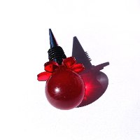 Red flower-shaped handcrafted epoxy bottle stopper with delicate petal details
