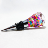 Handcrafted crystal-shaped epoxy bottle stopper filled with a vibrant variety of colorful gemstones for a luxurious and joyful look