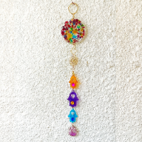 Handcrafted decorative wall hanging featuring a colorful mosaic disk and three layered Hamsa charms in vibrant colors.